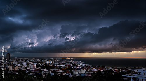 Dramatic Thunderstorm with Lightning Over Coastal City at Twilight