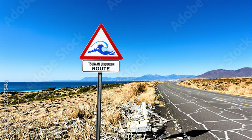 Tsunami Evacuation Route sign on coastal road with ocean view