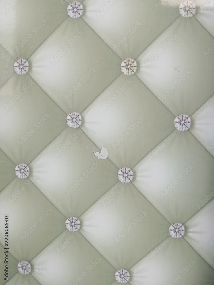 Fototapeta premium Upholstered leather wall panel texture background. Features diamond tufted design with decorative buttons. Luxury interior decoration material for modern home and office space.