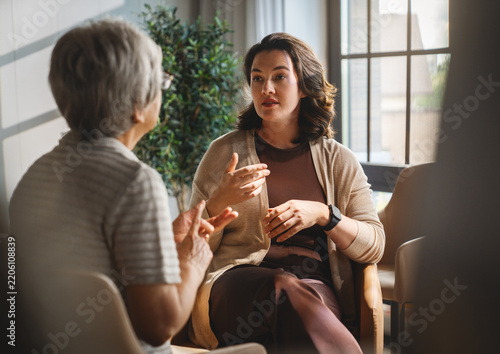 Therapist and Elderly Woman Having Supportive Conversation