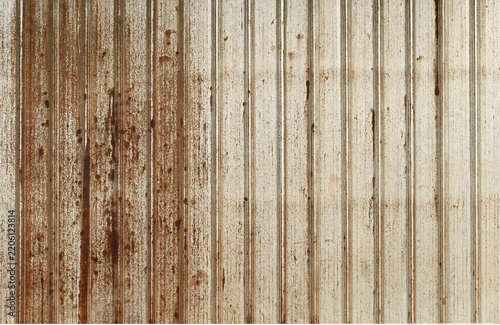 Texture or background of Rusted, aged galvanized sheet metal wall surface; weathered galvanized steel fence; retro concept; the artistry of old, rusty galvanized sheeting; vintage-style metal panels.
