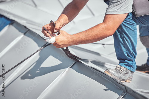 Roofer working on a roof replacement and reconstruction.