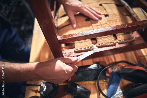 Man working in a workshop for furniture repairing and restoration.