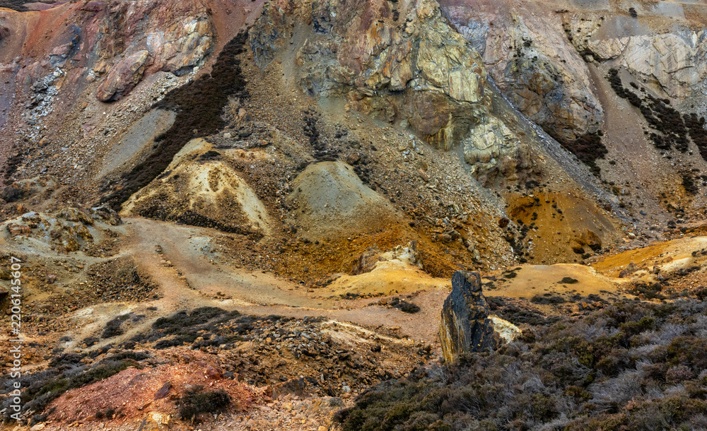 Obraz premium Colorful mineral soil and vibrant quarry rock formations at Parys Mountain copper mine