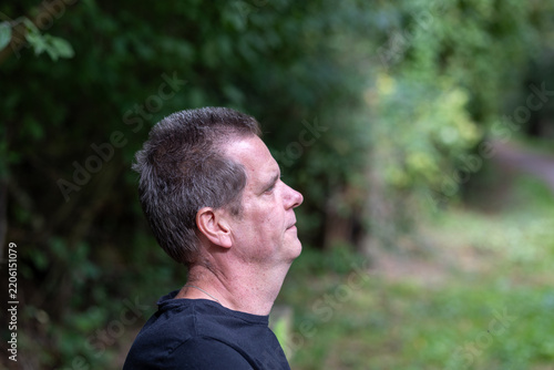 Man contemplating outdoors in forest enjoying nature