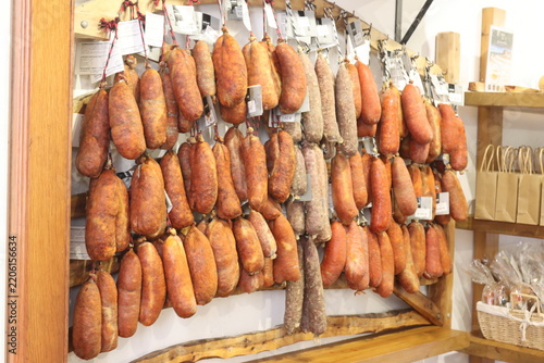 Assortment of hanging cured sausages in a traditional delicatessen