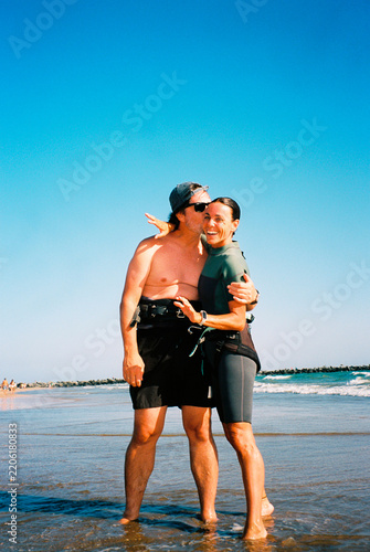 Surfer mid-age Couple on Beach