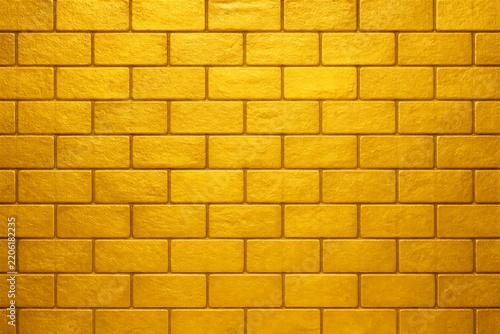Textured gold brick wall with metallic sheen and uniform pattern