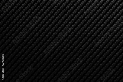 Carbon fiber texture showing diagonal weave on black surface