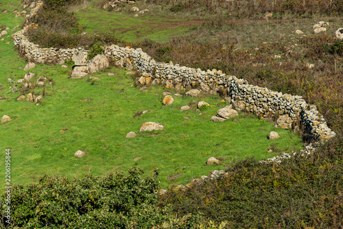 Italy, Sardinia, Macomer. Ramshackle stone walls delineating farm fields.
