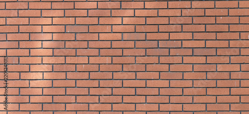 Full frame red brick wall texture background featuring a classic masonry pattern with warm terracotta tones, subtle surface scratches, and dark mortar joints for architectural design.