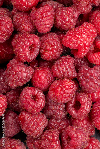 Fresh red raspberries filling frame macro view