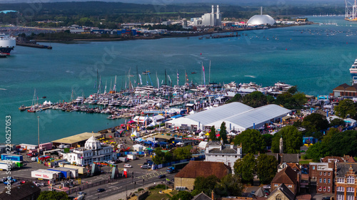 Aerial view of the Southampton International Boat Show featuring yachts docked in the marina and large white exhibition marquees along the waterfront in Southampton, England, United Kingdom.