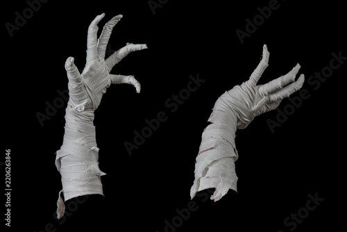 Mummy's hands wrapped in a bandage creepily moving on isolated background. The hand of the mummy monster for Halloween horror concept