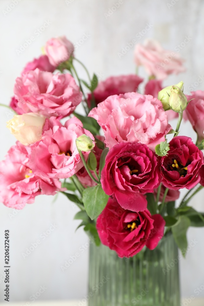 Obraz premium Eustoma flowers in glass vase indoors, closeup