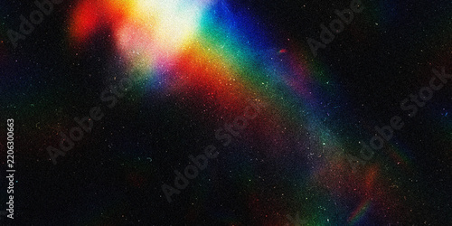 Abstract rainbow light prism effect on a dark textured background