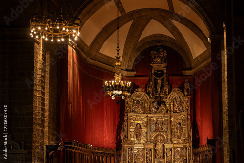 Ornate altarpiece and glowing chandeliers in valladolid church