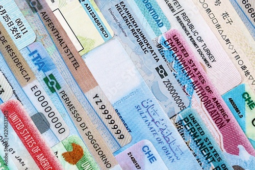 Many permanent resident cards or residence permit cards on table close up