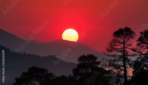 red sun with trees and mountains