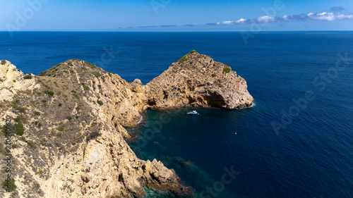 Drone view javea coast with anchored boat
