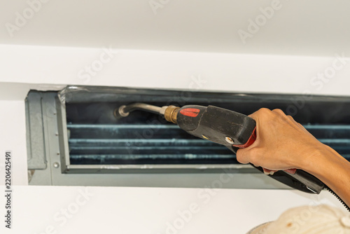 Worker performing operation to clean internal equipment of central air conditioner