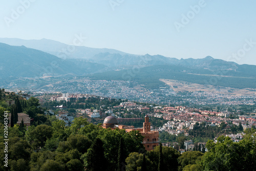 View of Granada, Spain, looking out over the city and the surrounding Sierra Nevada mountain range from an elevated vantage point
