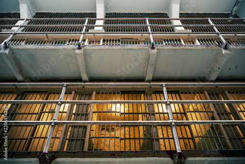 View looking up at the interior ceiling and cell blocks of a historic prison