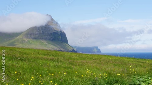 View of Mountains and Green Meadow with View of Ocean in Summer of Faroe Islands