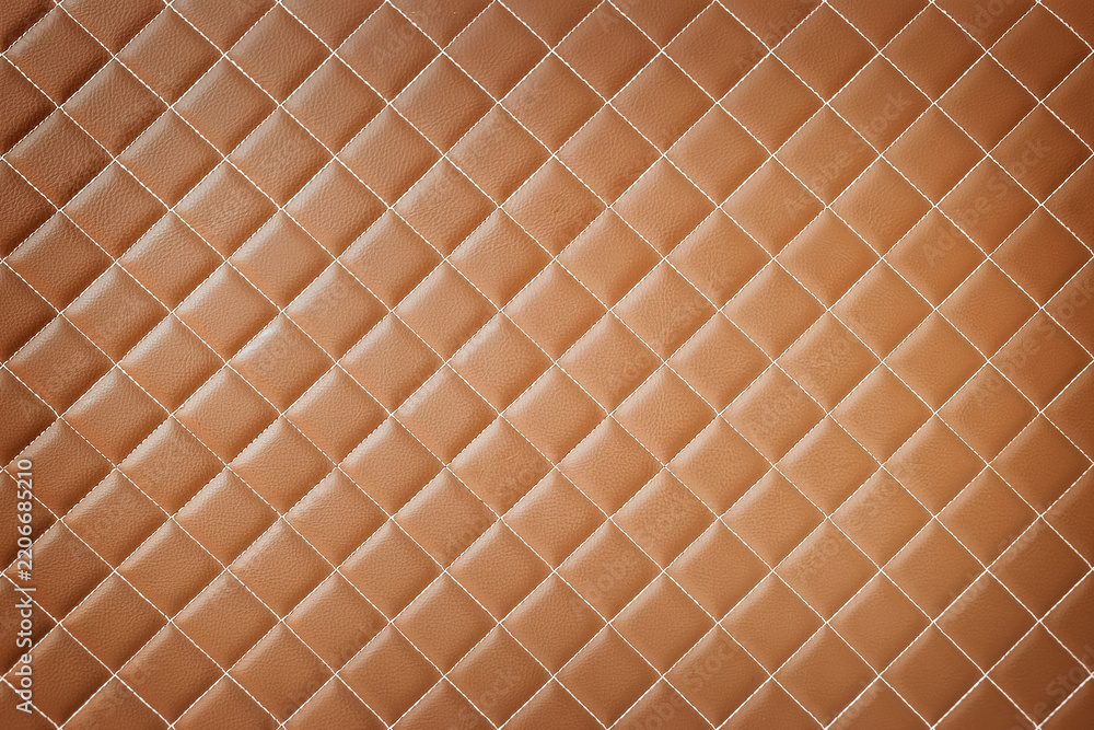 Obraz premium Brown quilted leather texture background with white stitched diamond pattern