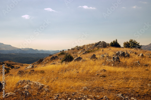 Dry Mountain Landscape with Golden Grass and Rocky Hills Under Dramatic Sky, Bjelasnica, Bosnia and Herzegovina