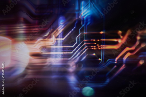Blurred futuristic circuit board with glowing data pathways and digital technology