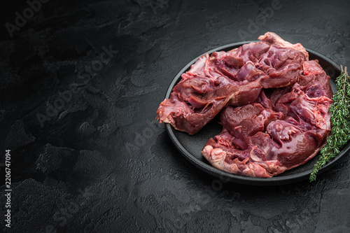 Fotografie lamb and goat hearts opened for prep on black surface perfect for stuffing stews pan frying and bold nose to tail cuisine