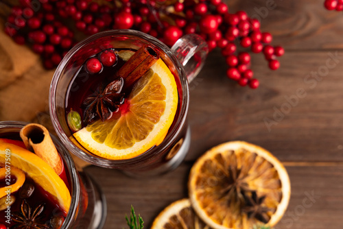 Winter mulled wine drink made with spices citrus and berries served in a glass mug
