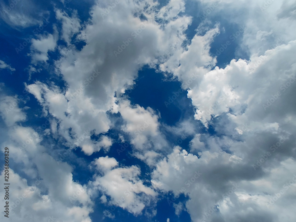 Fototapeta premium Fluffy White Cumulus Clouds in Deep Blue Sky Background.