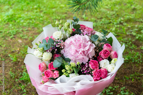 Pink hydrangea and rose bouquet wrapped in paper