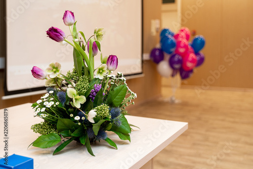 Floral arrangement with tulips and small blossoms on clean surface.