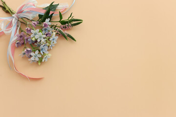 Top view image of romantic and delicate flowers on pastel background