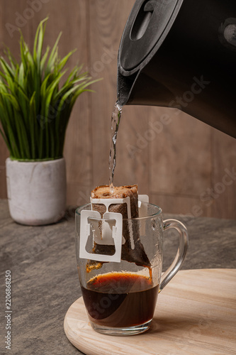 Boiling Water Poured into Drip Bag on Coffee Cup