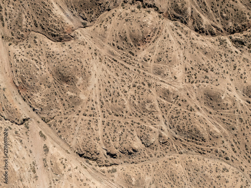 Aerial view of barren desert hills and rugged terrain landscape