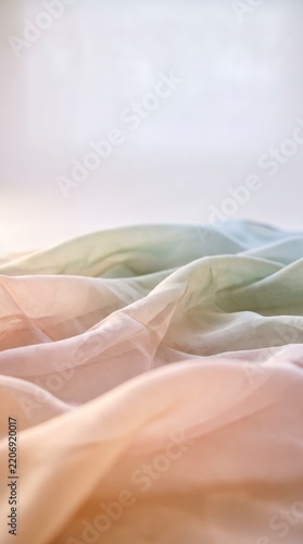 Flowing pastel silk fabric layers forming soft dunes, representing fluidity and gentle calm