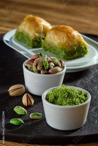 Delicious authentic Turkish dessert baklava with pistachio filling and nuts served on a plate