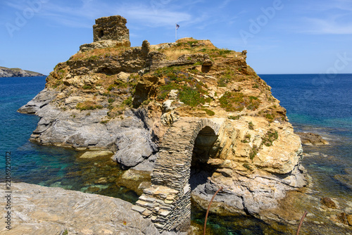 The old arched stone bridge to the Venetian castle islet at Chora, Andros. Cyclades, Greece