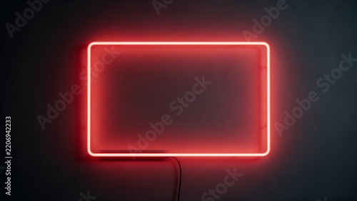 Empty red neon rectangle frame on dark wall sale banner
