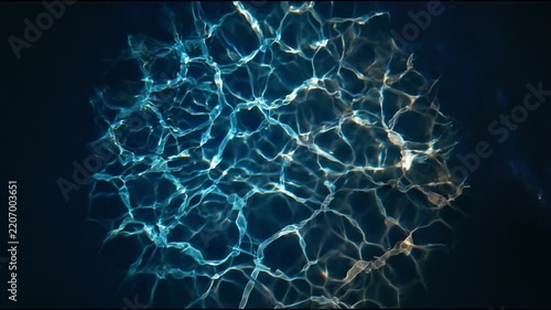 Dynamic Water Surface Reflections Creating Abstract Shimmering Light Patterns on Deep Water