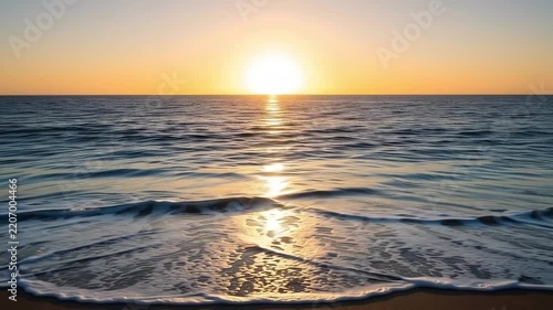 Golden Sunset Over Ocean Waves Gently Lapping on Sandy Beach Shoreline
