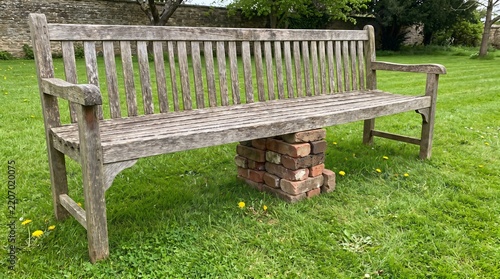 Make Do and Mend: Garden Bench Propped on a Stack of Bricks Where a Leg Has Broken