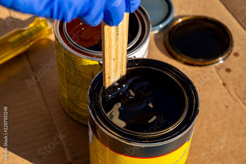 Can of wood stain with a mixing stick