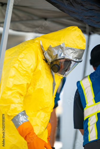 Man in a hazmat suit with duct taped sleaves