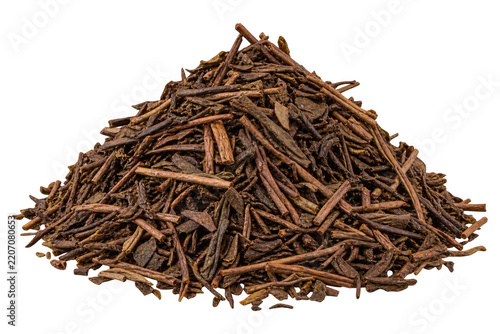 Heap of dry roasted hojicha green tea on black background