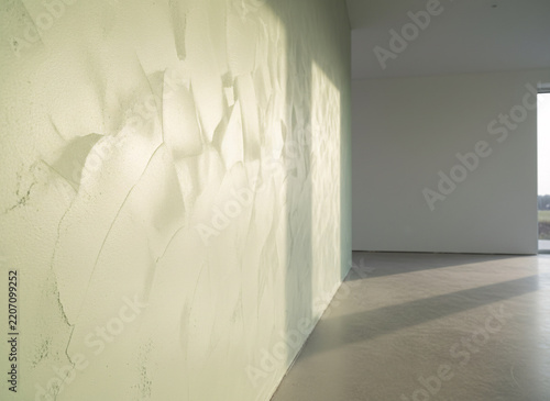 Fresh lime plaster troweled on a wall, everything clean and newly maintained, soft directional daylight